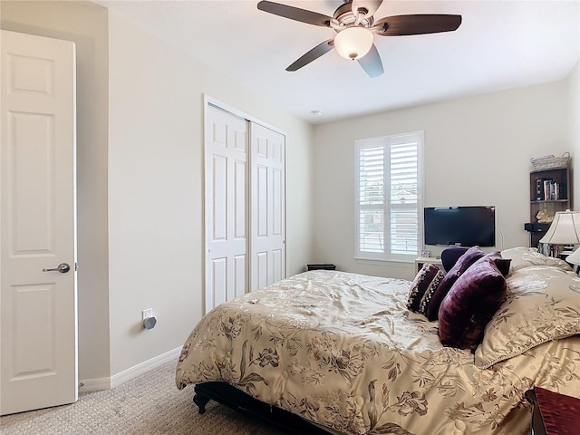 carpeted bedroom featuring a closet and ceiling fan