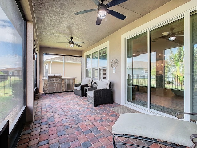 sunroom / solarium featuring ceiling fan