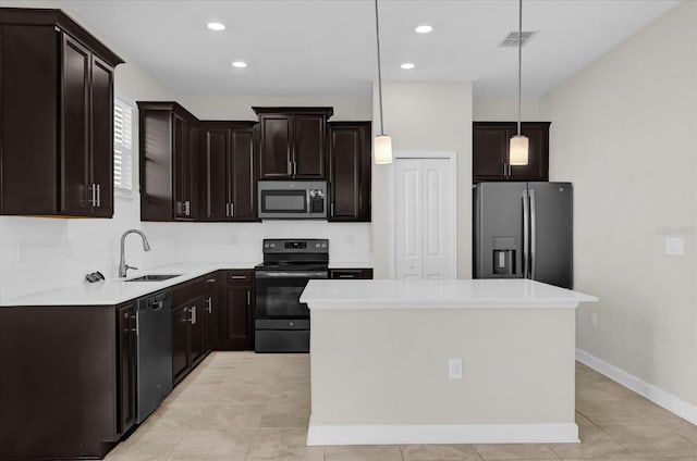 kitchen featuring black appliances, pendant lighting, a kitchen island, and sink