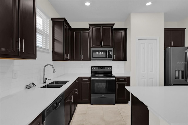 kitchen featuring sink, stainless steel appliances, tasteful backsplash, dark brown cabinets, and light tile patterned floors