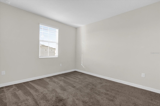 empty room with dark colored carpet