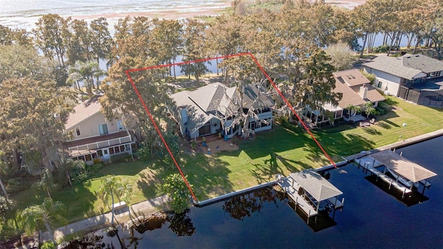 birds eye view of property with a water view