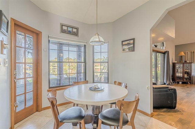 tiled dining room with plenty of natural light and french doors