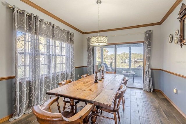 dining area featuring plenty of natural light and crown molding