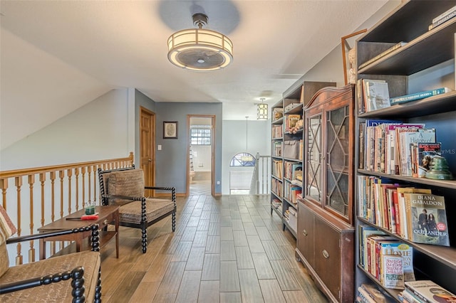 living area featuring light hardwood / wood-style flooring and lofted ceiling