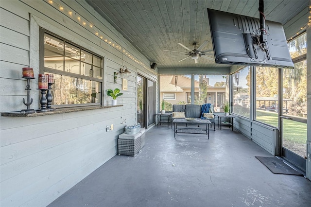 unfurnished sunroom with ceiling fan and wood ceiling