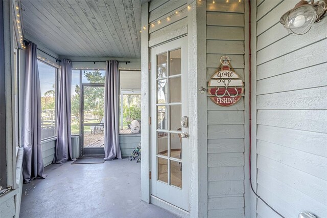 unfurnished sunroom featuring wooden ceiling