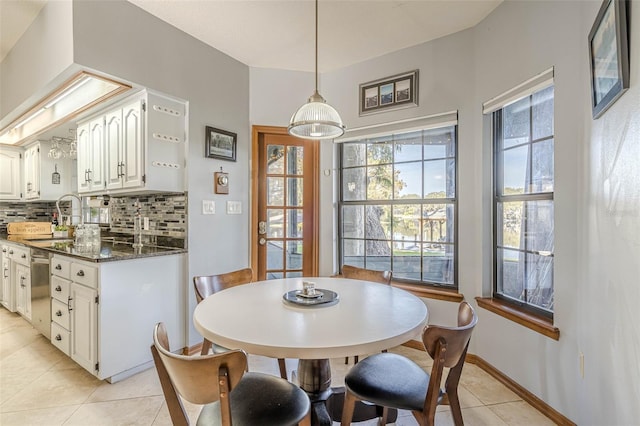 tiled dining space featuring sink