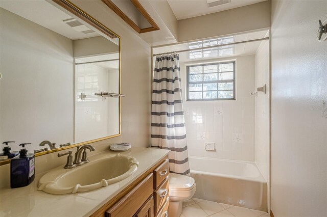 full bathroom featuring toilet, vanity, tile patterned flooring, and shower / bath combo with shower curtain