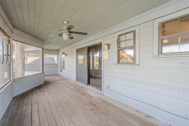 unfurnished sunroom featuring ceiling fan and wooden ceiling