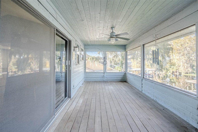 unfurnished sunroom with ceiling fan and wood ceiling