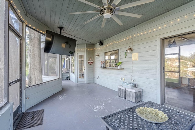 sunroom / solarium featuring ceiling fan and wood ceiling