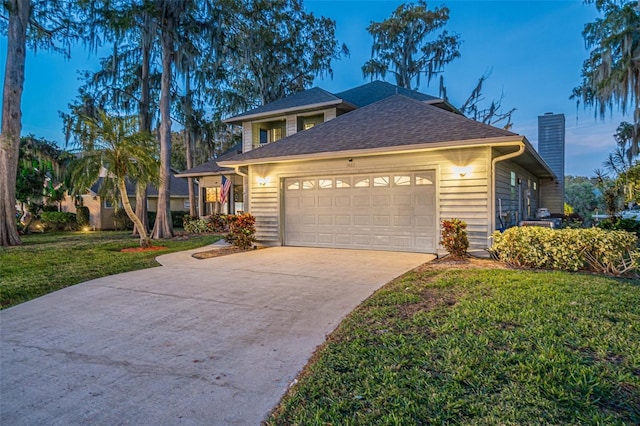 view of front facade with a lawn and a garage