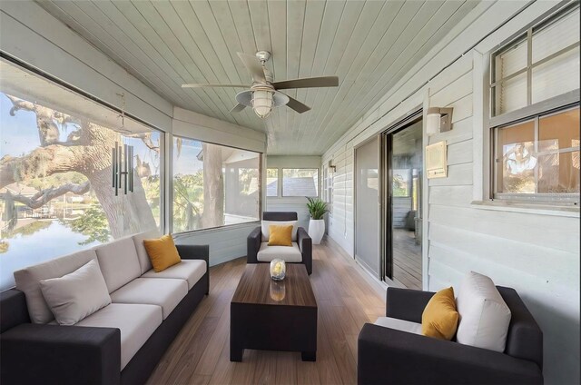 sunroom / solarium featuring ceiling fan and wood ceiling