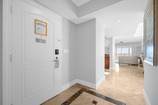 entryway featuring ceiling fan and light tile patterned floors