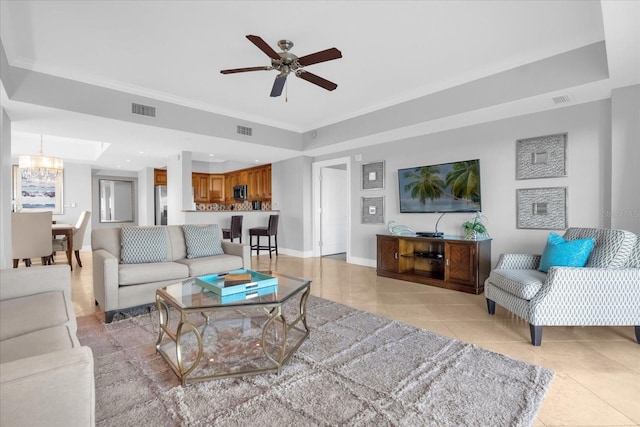 living room featuring ceiling fan with notable chandelier and light tile patterned floors