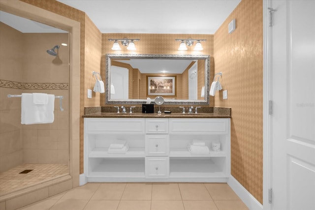 bathroom with tile patterned floors, vanity, and tiled shower