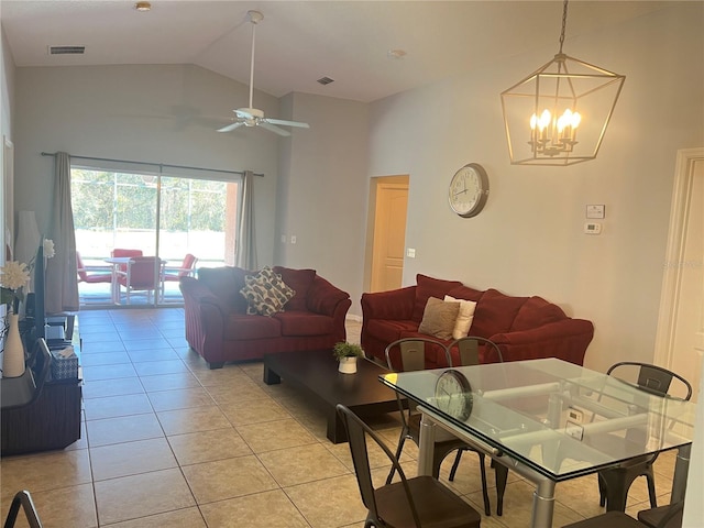 living room with light tile patterned floors, ceiling fan with notable chandelier, and high vaulted ceiling