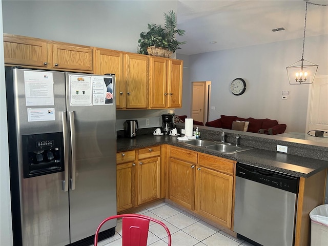 kitchen featuring stainless steel appliances, sink, an inviting chandelier, hanging light fixtures, and light tile patterned flooring