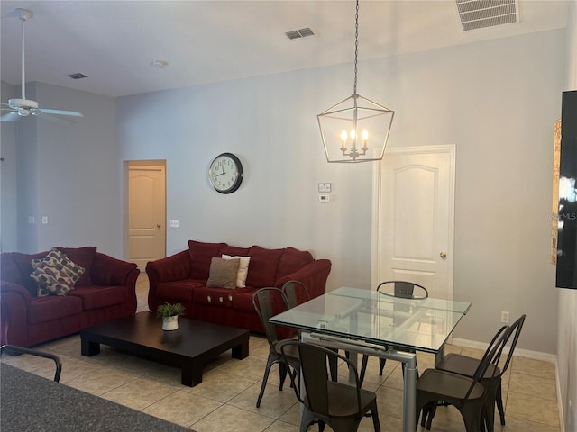 interior space with ceiling fan with notable chandelier and light tile patterned floors