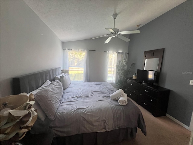 carpeted bedroom featuring a textured ceiling, ceiling fan, and lofted ceiling