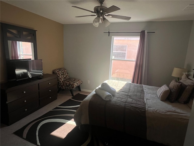 bedroom with light colored carpet and ceiling fan