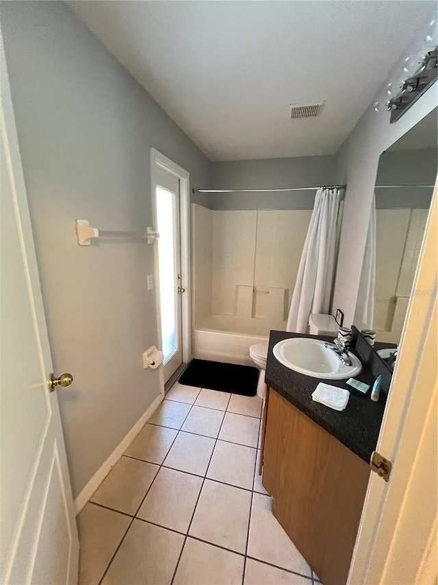 full bathroom with tile patterned flooring, shower / bath combo, vanity, and toilet