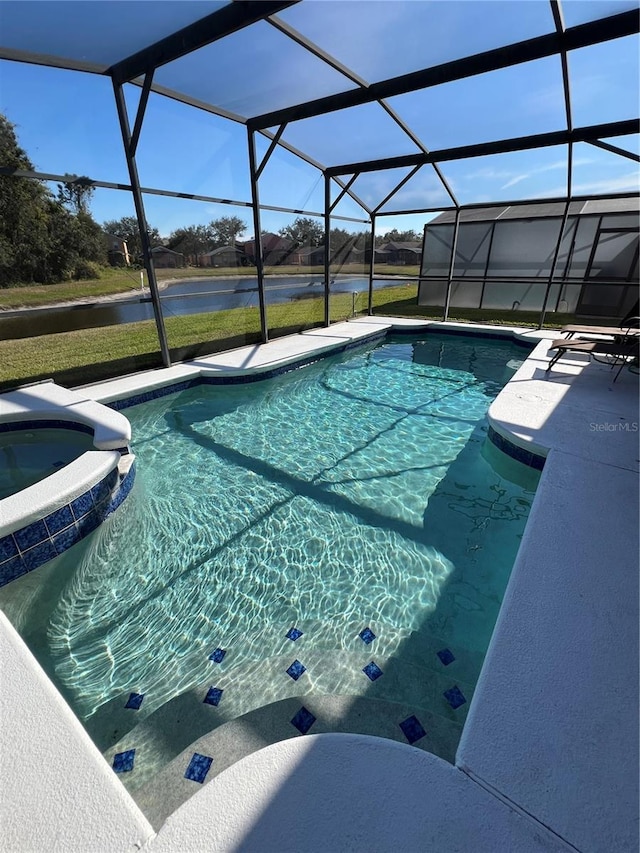 view of pool with glass enclosure, an in ground hot tub, and a water view