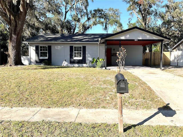 ranch-style home with a front lawn and a carport