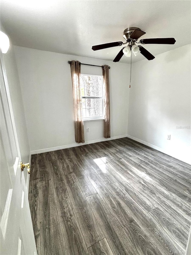 unfurnished room with dark hardwood / wood-style floors and ceiling fan