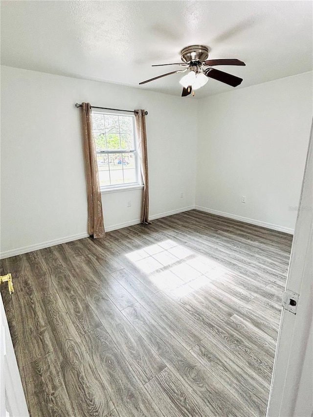 empty room featuring ceiling fan, a textured ceiling, and hardwood / wood-style flooring