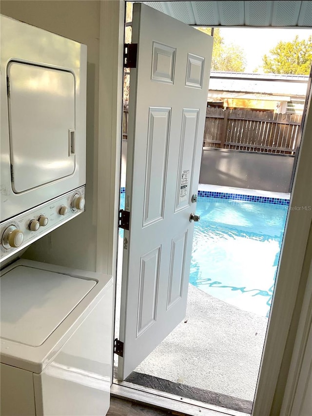 washroom featuring stacked washer / dryer