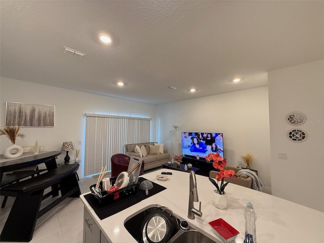 kitchen with light tile patterned flooring and a textured ceiling