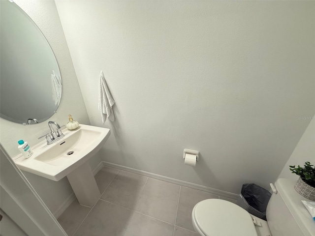 bathroom featuring sink, tile patterned flooring, and toilet