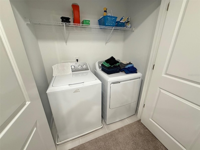 washroom with washer and dryer and light tile patterned floors