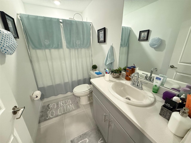 full bathroom featuring toilet, shower / tub combo, vanity, and tile patterned floors