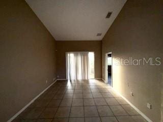 tiled empty room with high vaulted ceiling