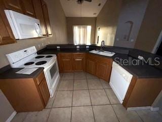 kitchen featuring white appliances, sink, ceiling fan, light tile patterned floors, and kitchen peninsula