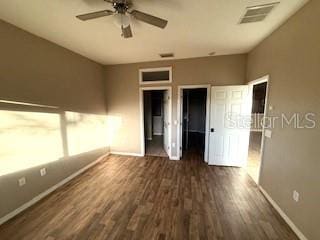 unfurnished bedroom with ceiling fan and dark wood-type flooring