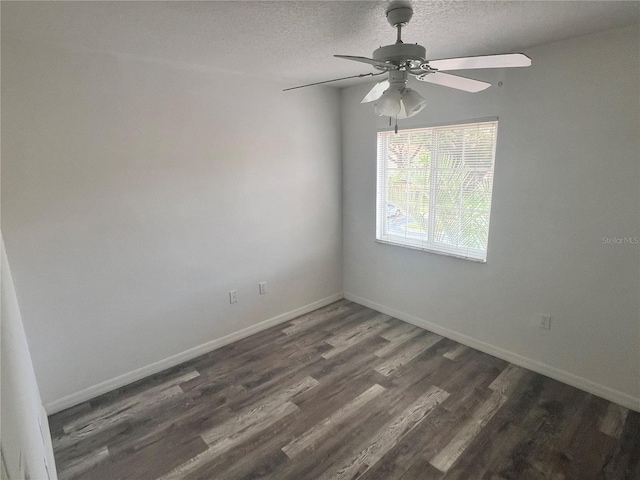 empty room with ceiling fan, dark hardwood / wood-style floors, and a textured ceiling