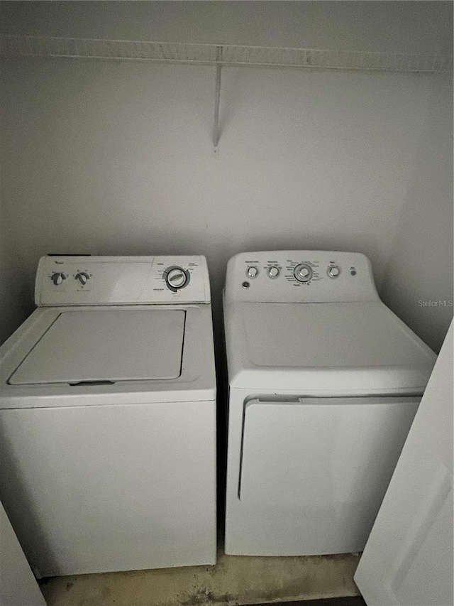 washroom with washing machine and clothes dryer