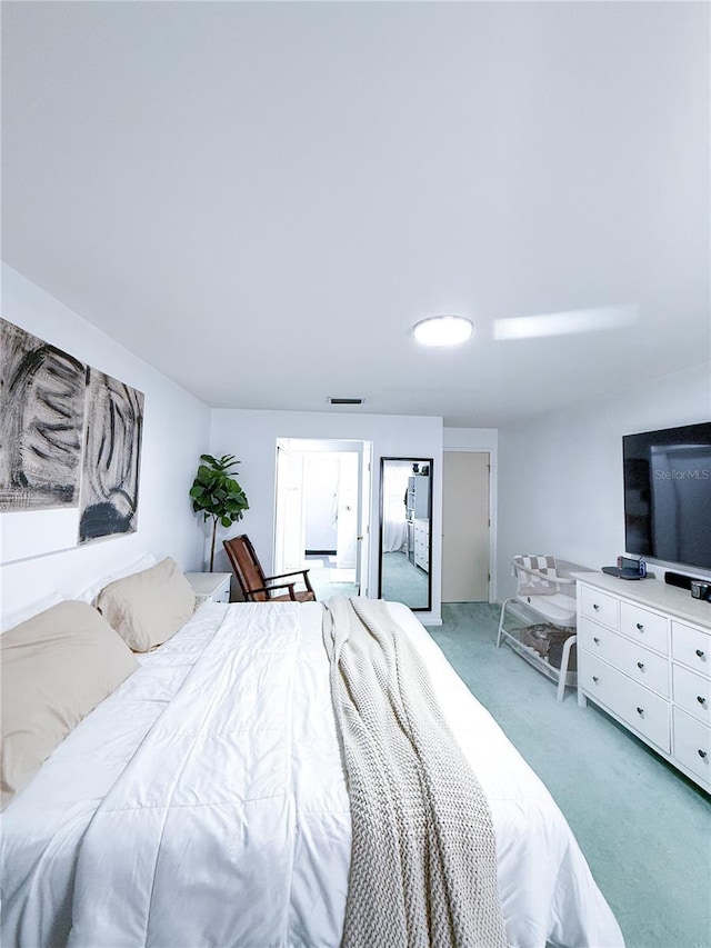 bedroom with light colored carpet