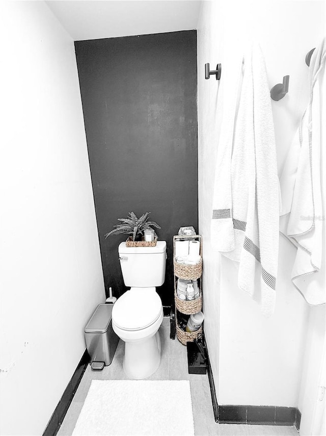 bathroom with tile patterned flooring and toilet