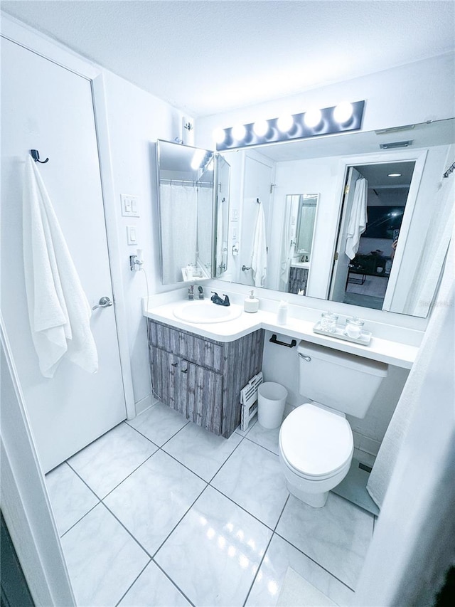 bathroom with tile patterned flooring, toilet, and sink