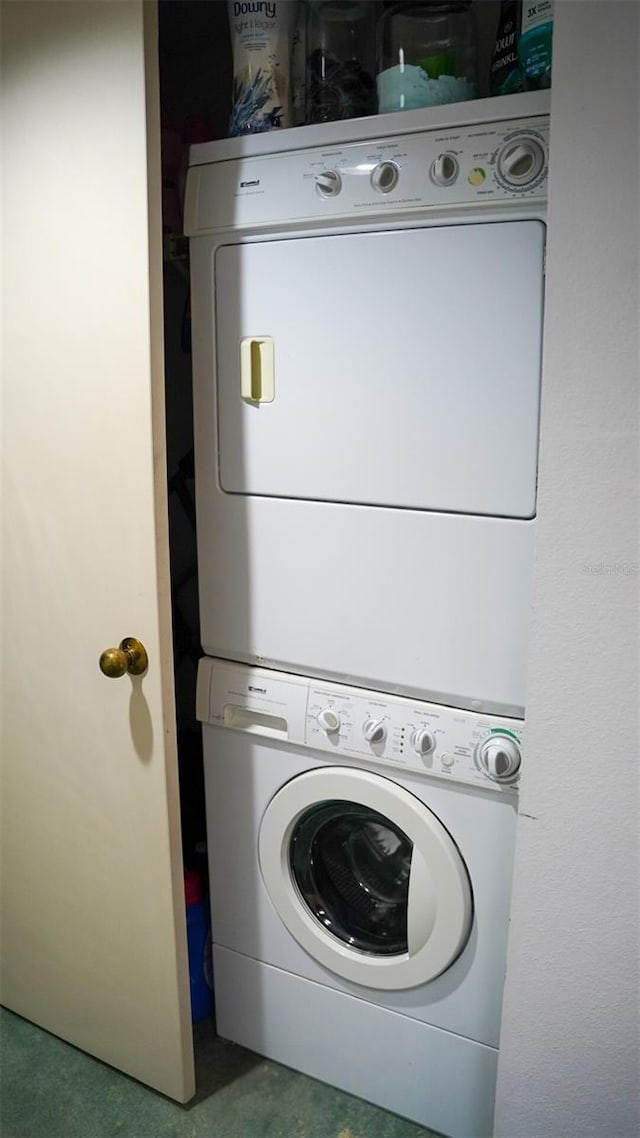 laundry area featuring stacked washing maching and dryer