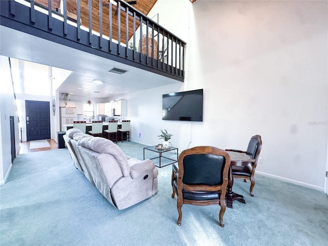 living room featuring carpet floors and a high ceiling