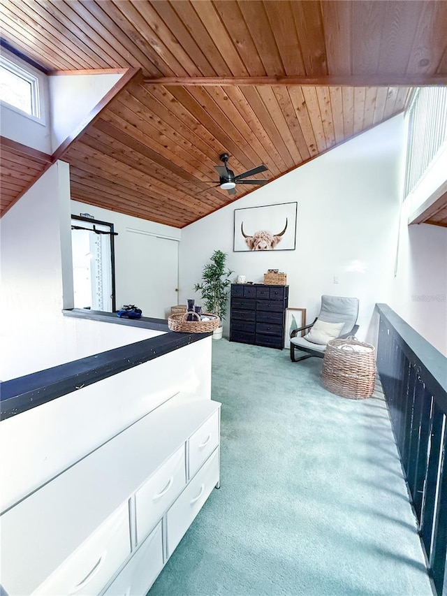 interior space featuring ceiling fan, carpet floors, wooden ceiling, and vaulted ceiling