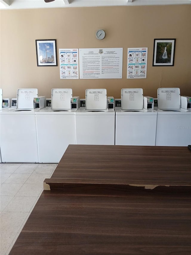 washroom with tile patterned floors and washing machine and dryer