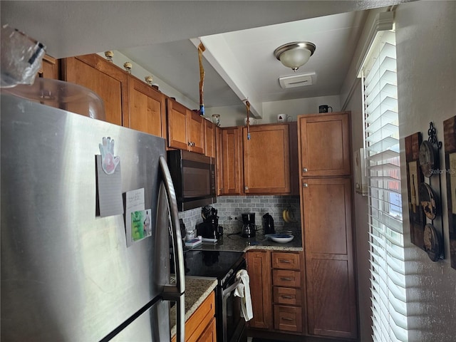 kitchen featuring decorative backsplash, a healthy amount of sunlight, light stone countertops, and appliances with stainless steel finishes