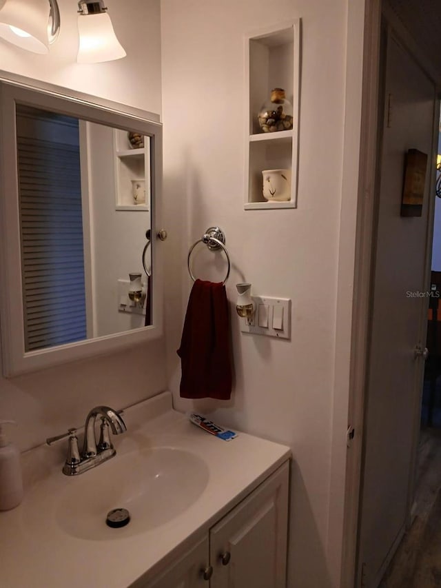 bathroom with built in shelves and vanity